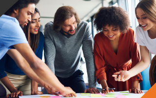 5 people from culturally diverse backgrounds in an office setting all implementing their diverse perspective