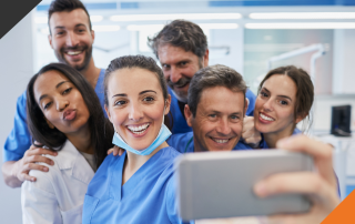 six healthcare workers gathered to take a selfie demonstrating stress management strategies for healthcare workers