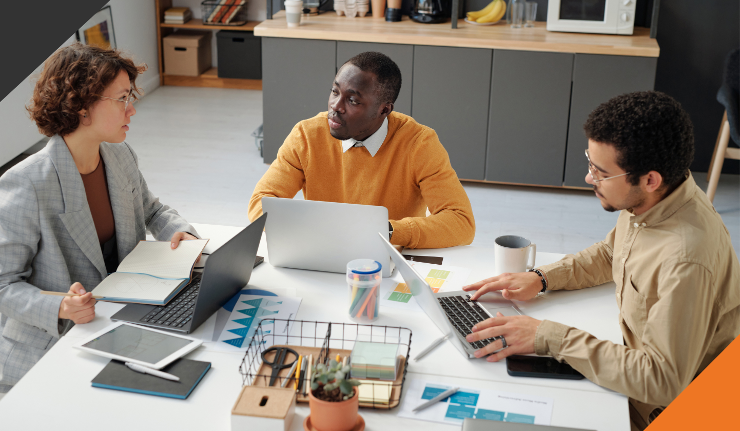 3 members of a leadership team practicing year-end team collaboration